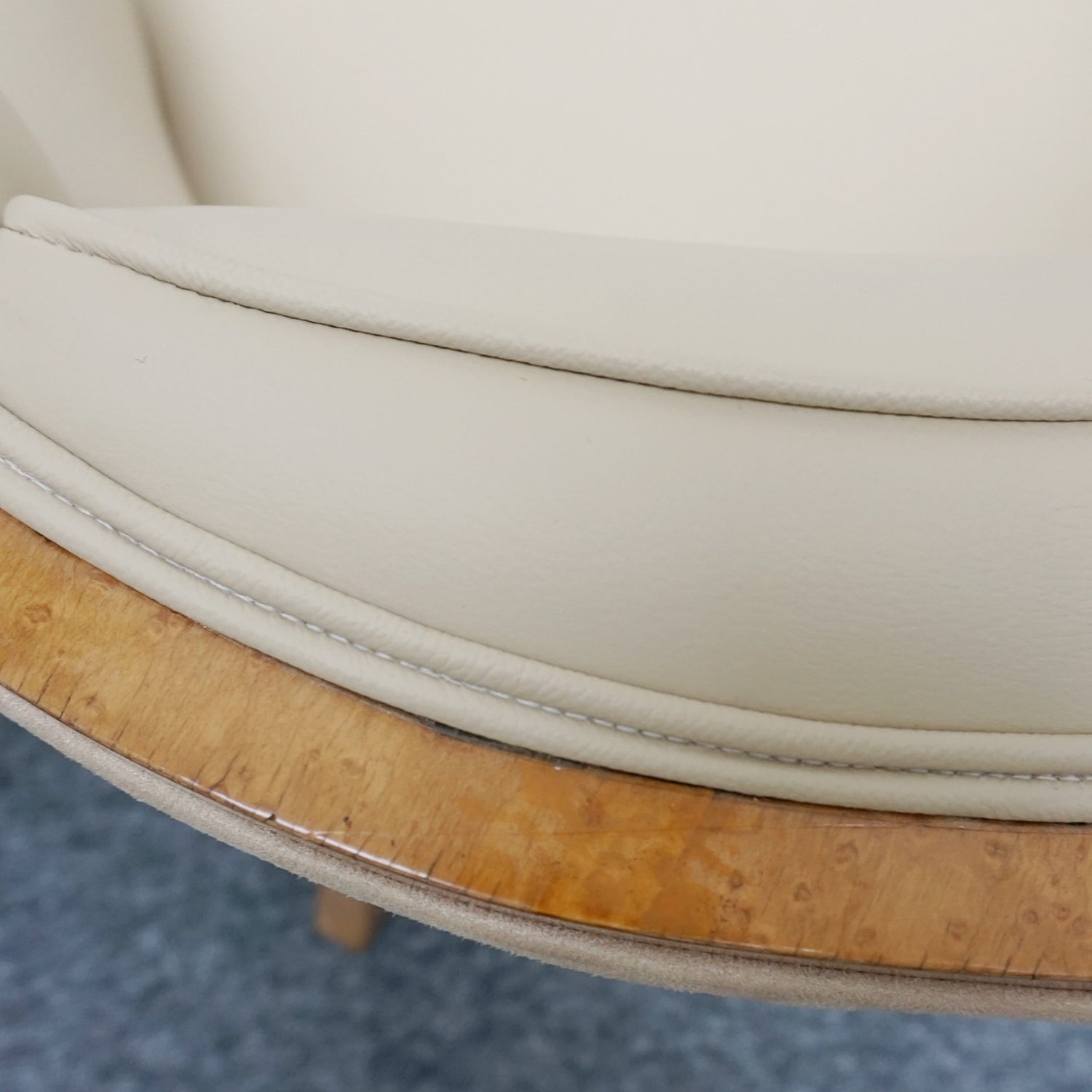 A pair of Art Deco bankers chairs birdseye maple veneered with solid satin birch legs. Upholstered in cream leather and contrasting oatmeal faux suede.