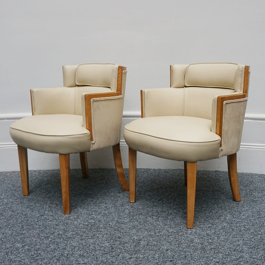 A pair of Art Deco bankers chairs birdseye maple veneered with solid satin birch legs. Upholstered in cream leather and contrasting oatmeal faux suede.