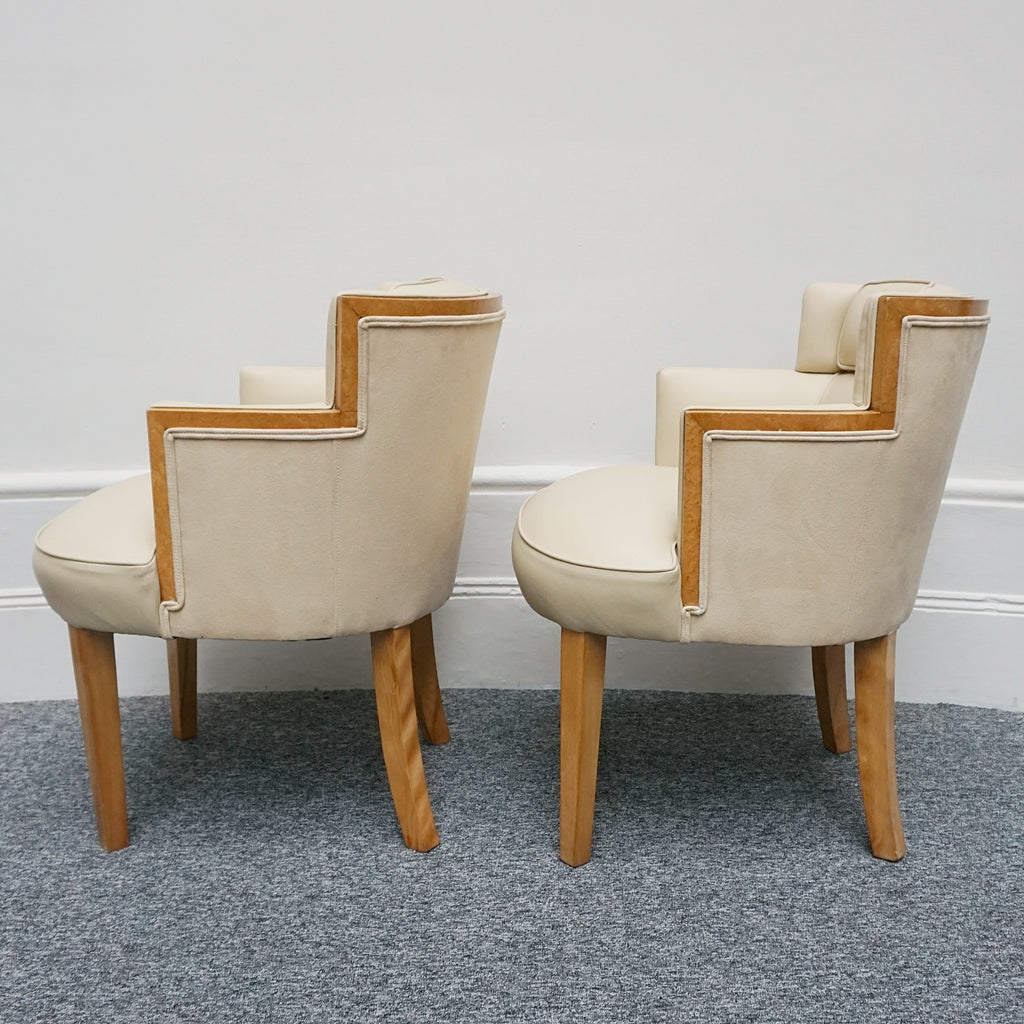 A pair of Art Deco bankers chairs birdseye maple veneered with solid satin birch legs. Upholstered in cream leather and contrasting oatmeal faux suede.