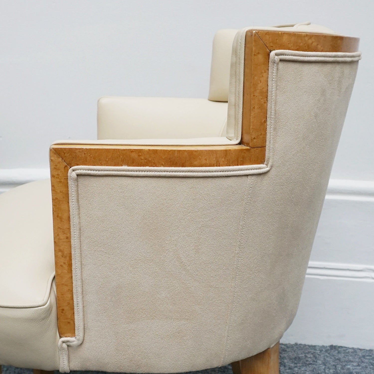 A pair of Art Deco bankers chairs birdseye maple veneered with solid satin birch legs. Upholstered in cream leather and contrasting oatmeal faux suede.