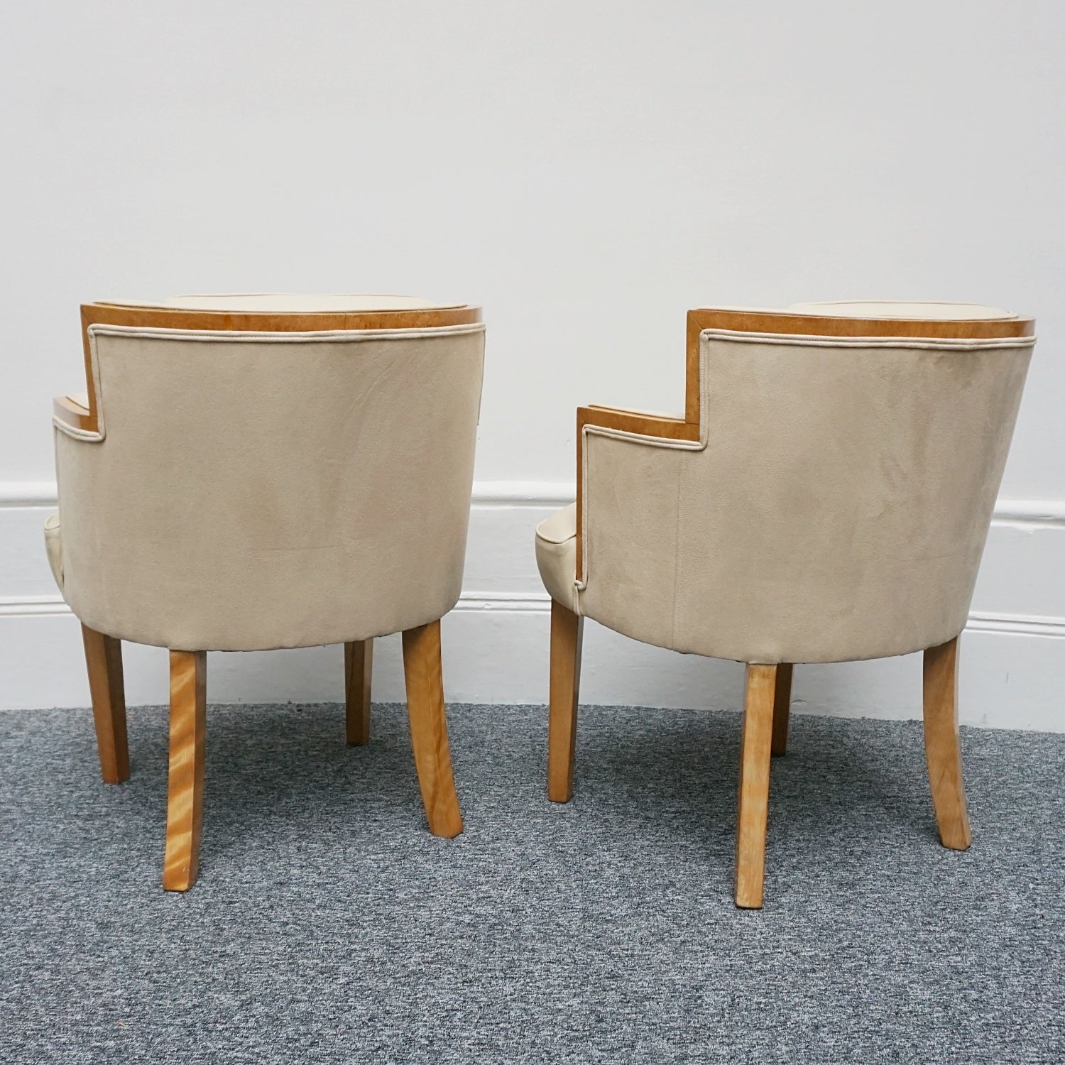 A pair of Art Deco bankers chairs birdseye maple veneered with solid satin birch legs. Upholstered in cream leather and contrasting oatmeal faux suede.