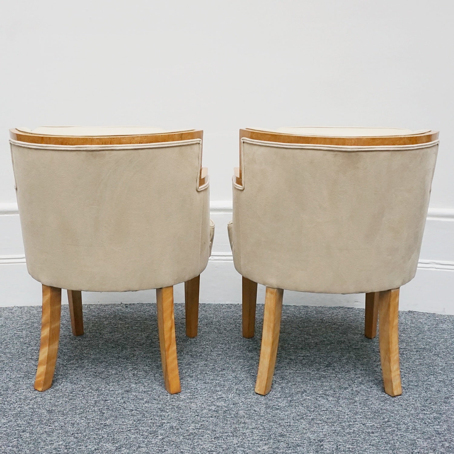 A pair of Art Deco bankers chairs birdseye maple veneered with solid satin birch legs. Upholstered in cream leather and contrasting oatmeal faux suede.