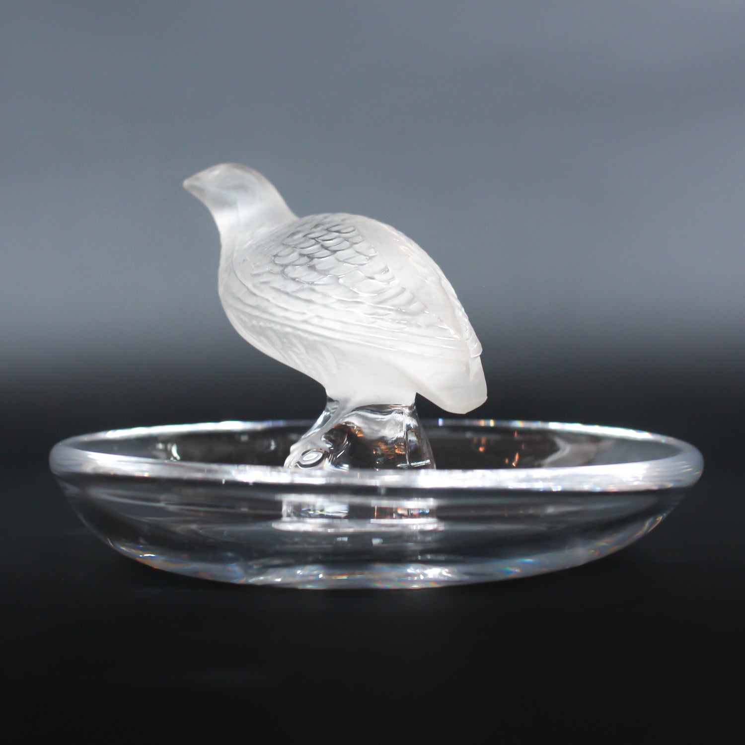 Detailed crystal ring dish by Lalique. Clear dish base topped with a frosted crystal Partridge. Signed to base at Jeroen Markies.