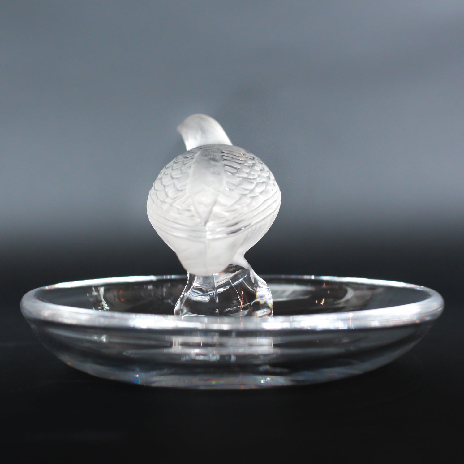 Detailed crystal ring dish by Lalique. Clear dish base topped with a frosted crystal Partridge. Signed to base at Jeroen Markies.