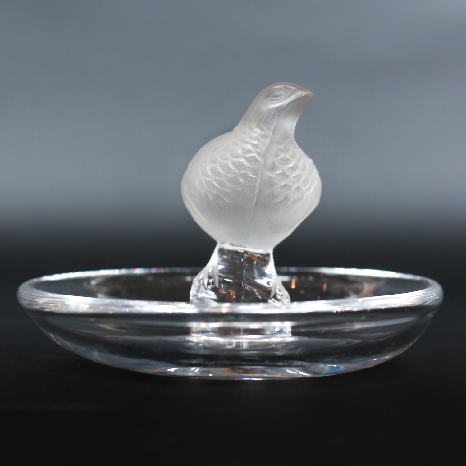 Detailed crystal ring dish by Lalique. Clear dish base topped with a frosted crystal Partridge. Signed to base at Jeroen Markies.