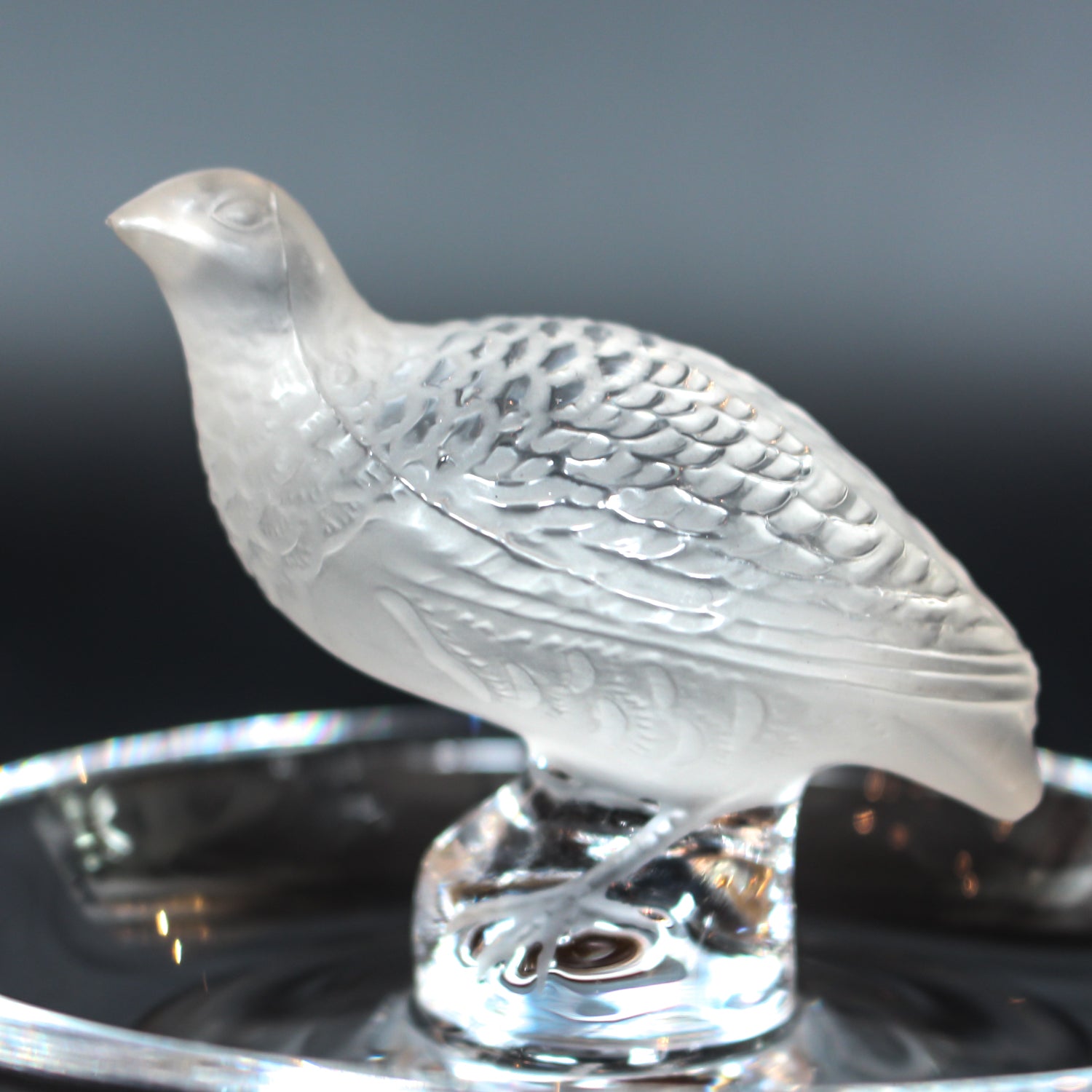 Detailed crystal ring dish by Lalique. Clear dish base topped with a frosted crystal Partridge. Signed to base at Jeroen Markies.