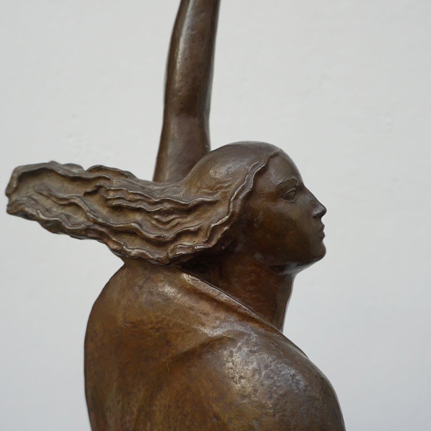 An Art Deco bronze sculpture of Ceres the Roman goddess of agriculture, fertility and motherly relationshios, holding alot a strand of wheat, bear breasted with a shawl around her and her hair flowing in the wind by André Bizette-Lindet 