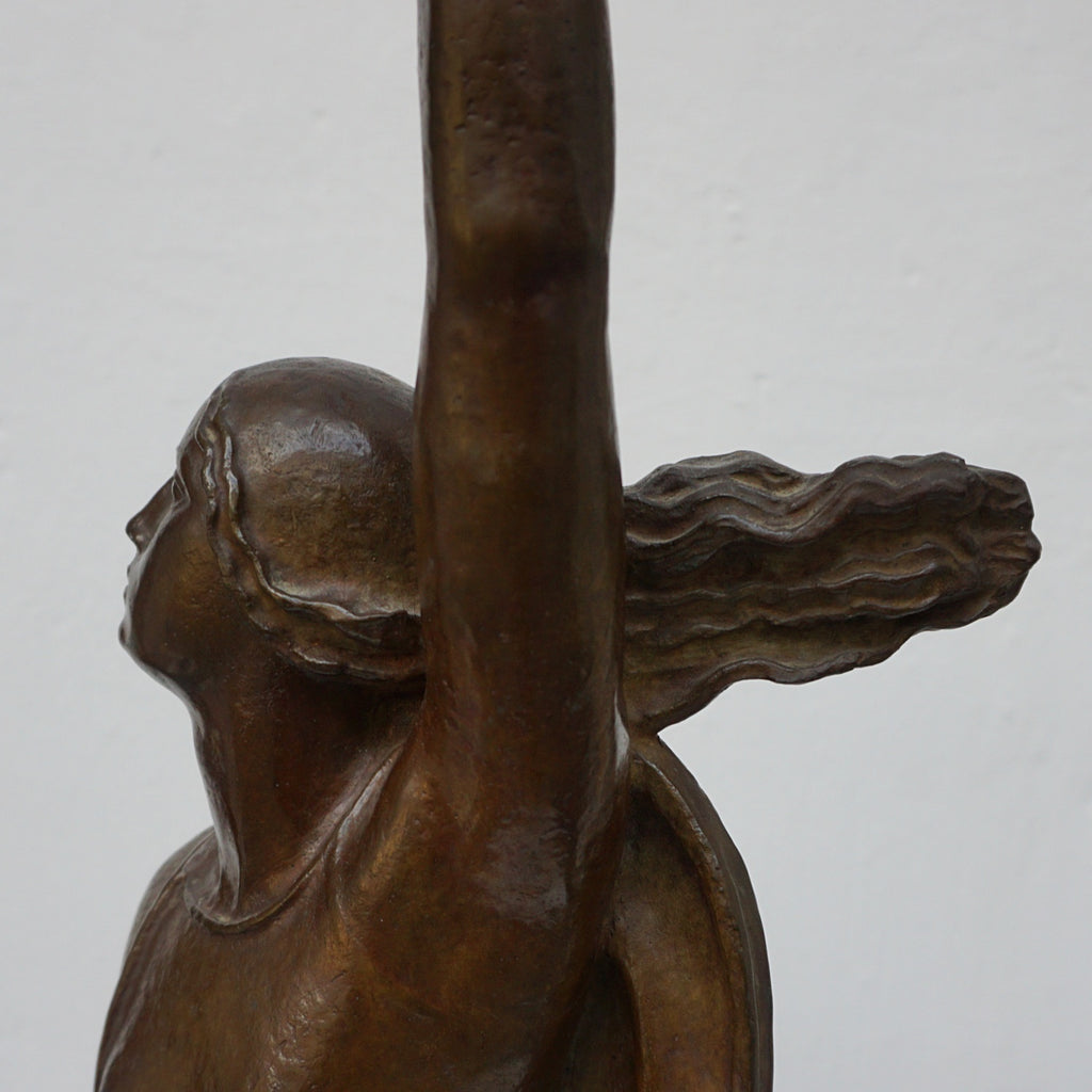 An Art Deco bronze sculpture of Ceres the Roman goddess of agriculture, fertility and motherly relationshios, holding alot a strand of wheat, bear breasted with a shawl around her and her hair flowing in the wind by André Bizette-Lindet 