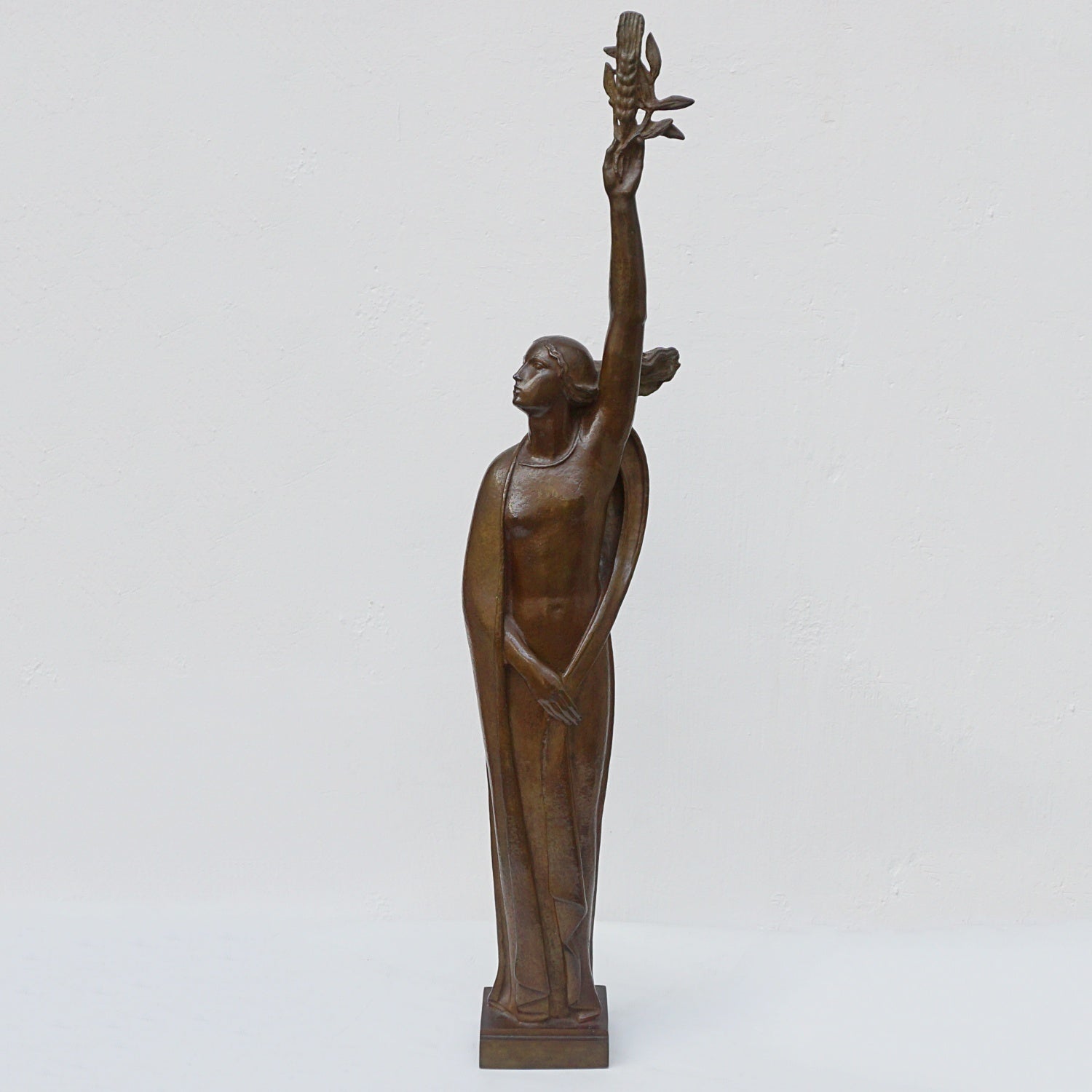 An Art Deco bronze sculpture of Ceres the Roman goddess of agriculture, fertility and motherly relationshios, holding alot a strand of wheat, bear breasted with a shawl around her and her hair flowing in the wind by André Bizette-Lindet 