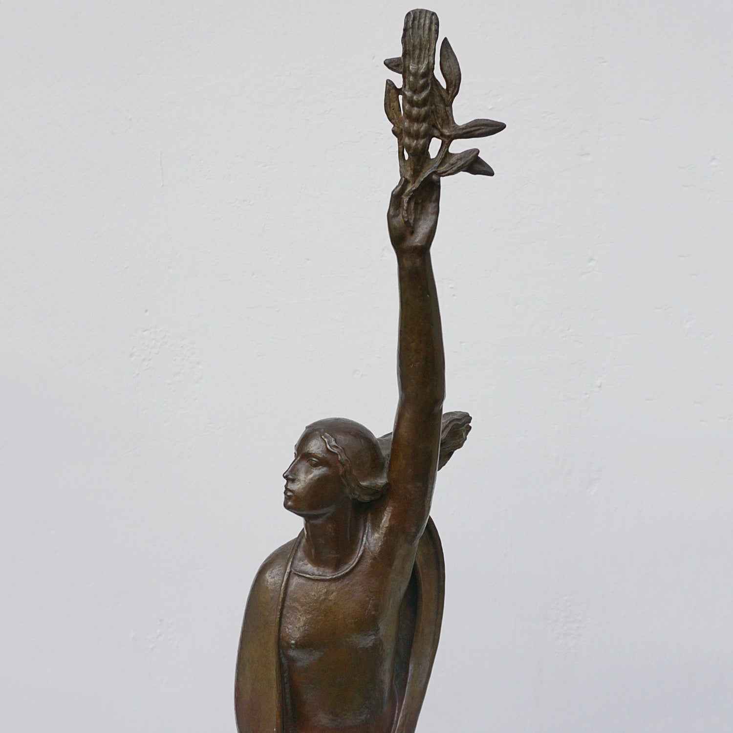 An Art Deco bronze sculpture of Ceres the Roman goddess of agriculture, fertility and motherly relationshios, holding alot a strand of wheat, bear breasted with a shawl around her and her hair flowing in the wind by André Bizette-Lindet 