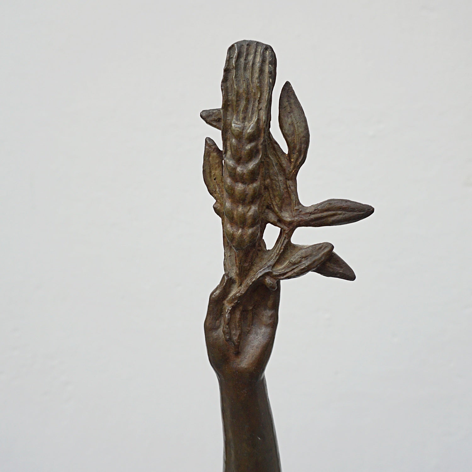 An Art Deco bronze sculpture of Ceres the Roman goddess of agriculture, fertility and motherly relationshios, holding alot a strand of wheat, bear breasted with a shawl around her and her hair flowing in the wind by André Bizette-Lindet 