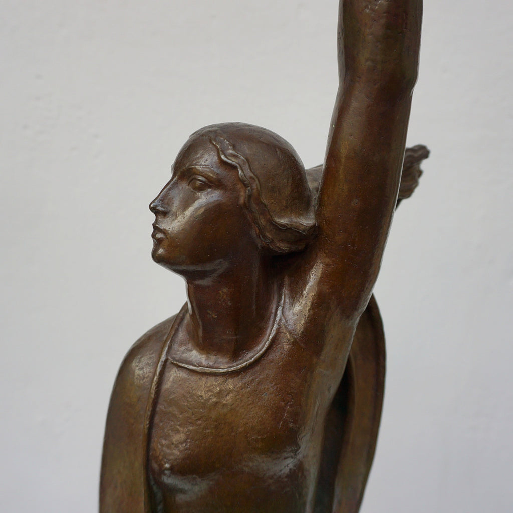 An Art Deco bronze sculpture of Ceres the Roman goddess of agriculture, fertility and motherly relationshios, holding alot a strand of wheat, bear breasted with a shawl around her and her hair flowing in the wind by André Bizette-Lindet 