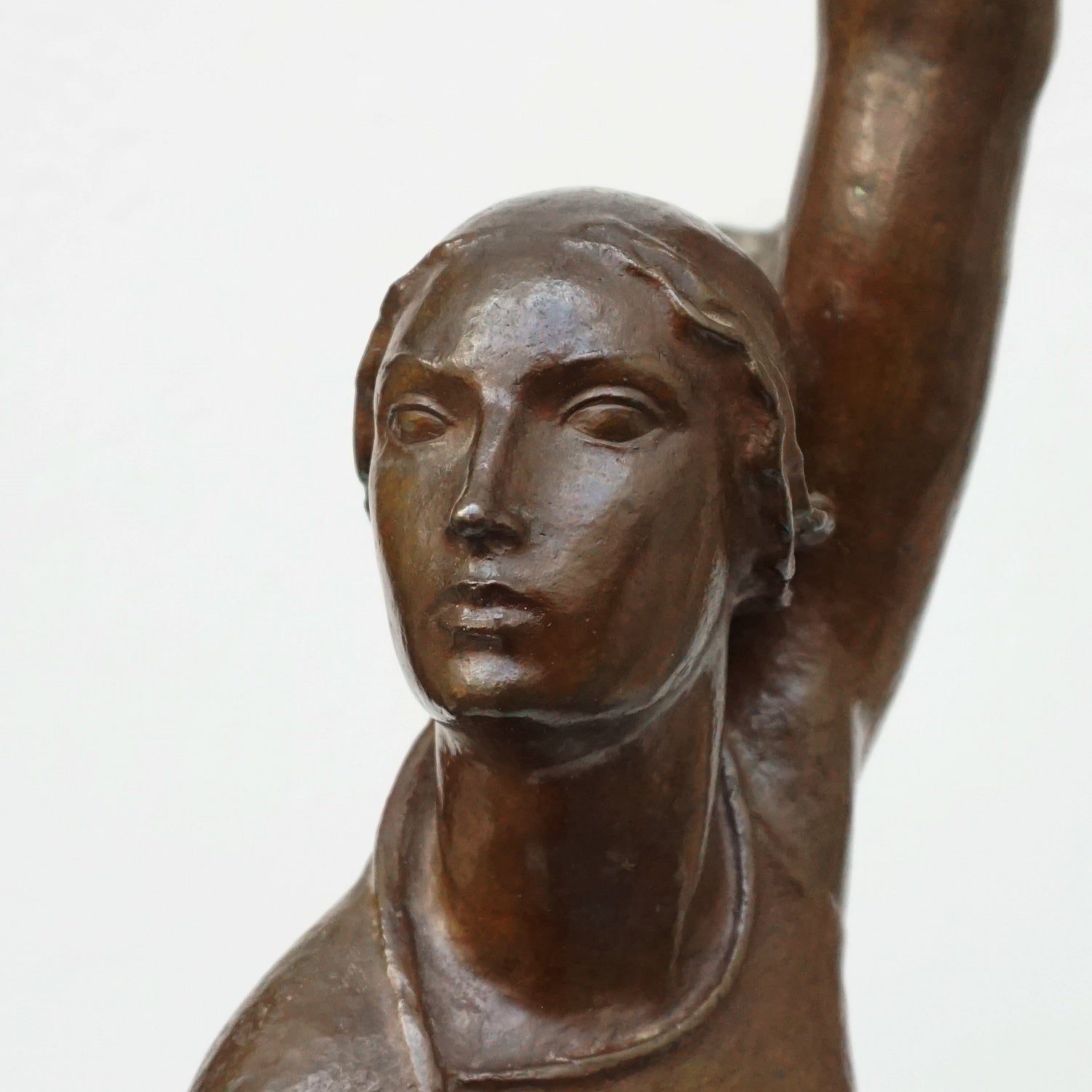 An Art Deco bronze sculpture of Ceres the Roman goddess of agriculture, fertility and motherly relationshios, holding alot a strand of wheat, bear breasted with a shawl around her and her hair flowing in the wind by André Bizette-Lindet 