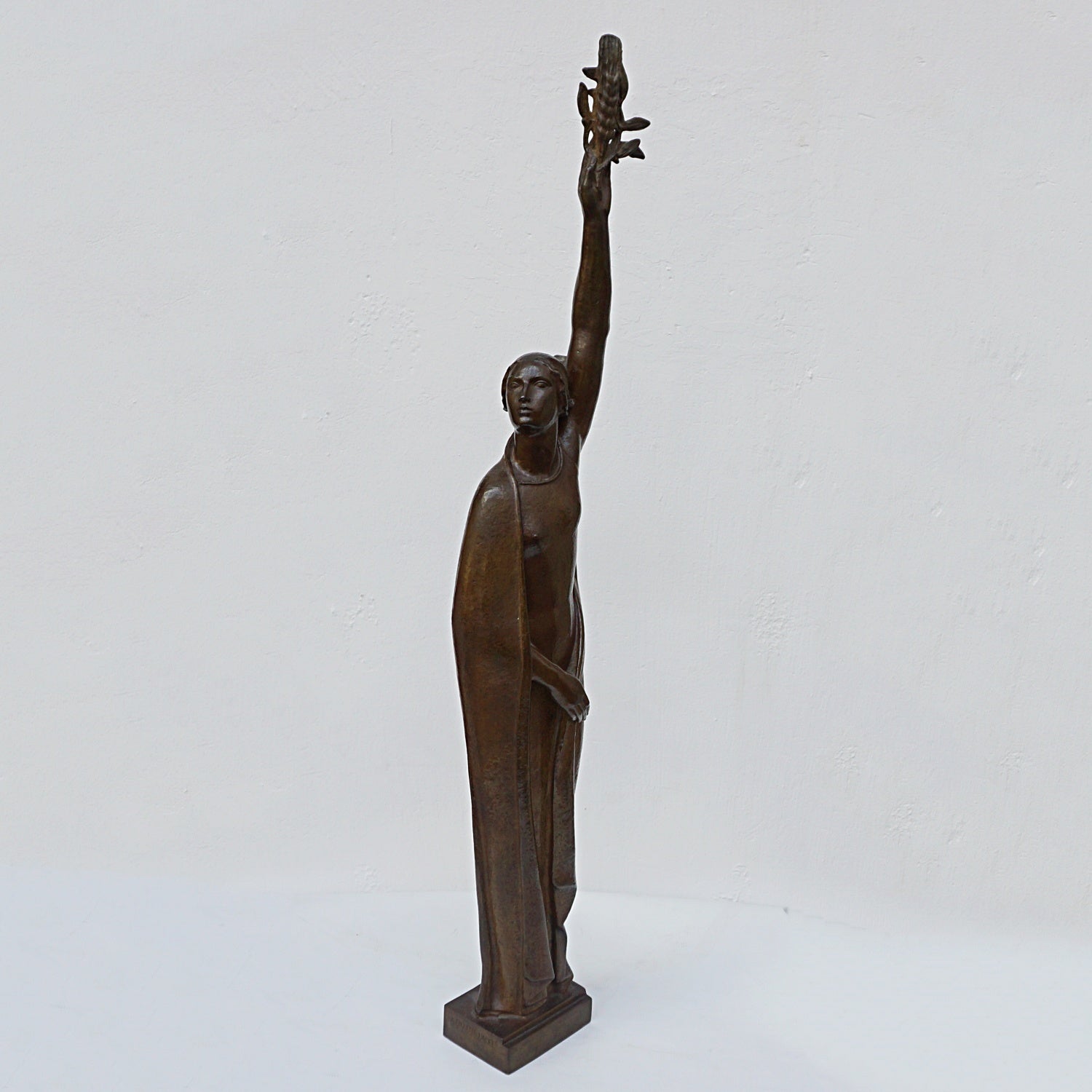 An Art Deco bronze sculpture of Ceres the Roman goddess of agriculture, fertility and motherly relationshios, holding alot a strand of wheat, bear breasted with a shawl around her and her hair flowing in the wind by André Bizette-Lindet 