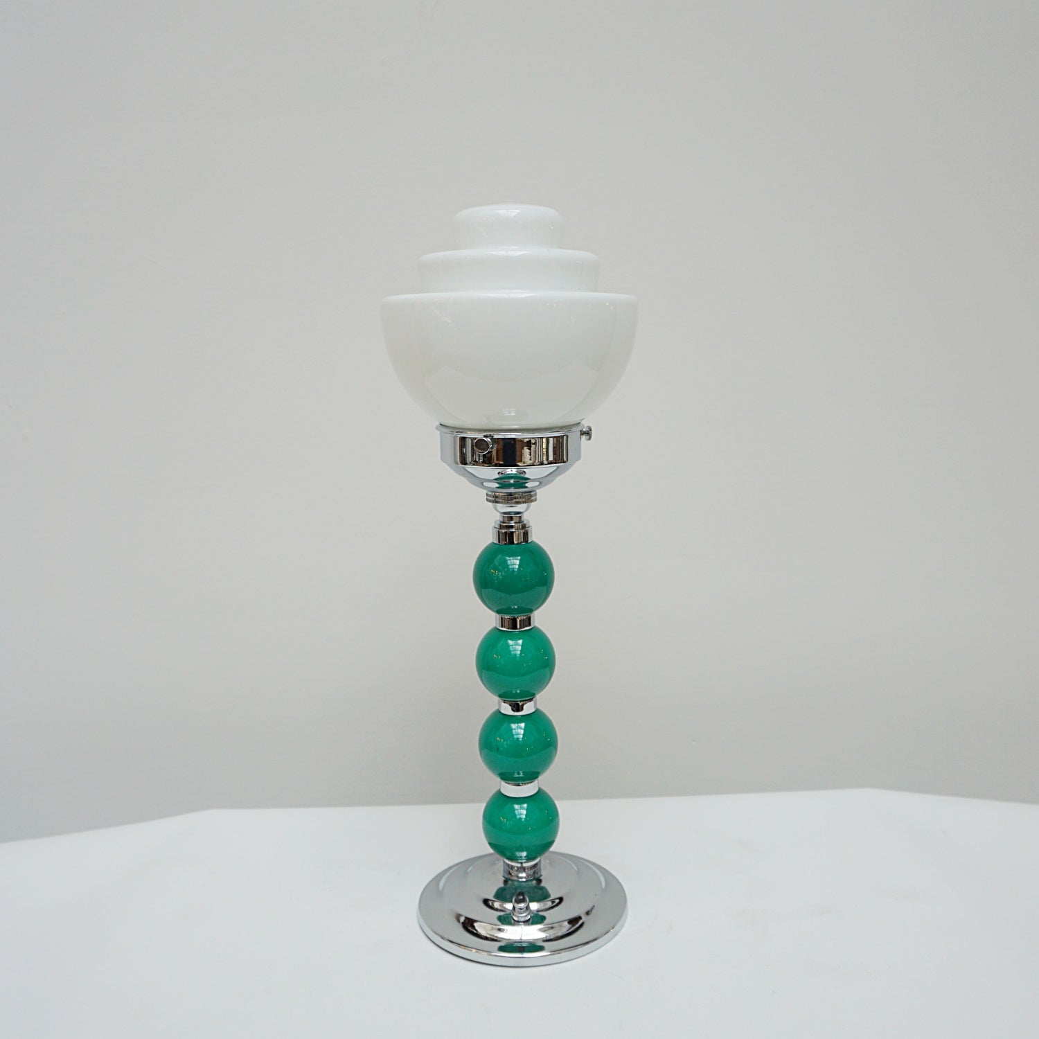 An Art Deco table lamp. Green bakelite balls with chromed banding to stem. Set over stepped circular base - Jeroen m