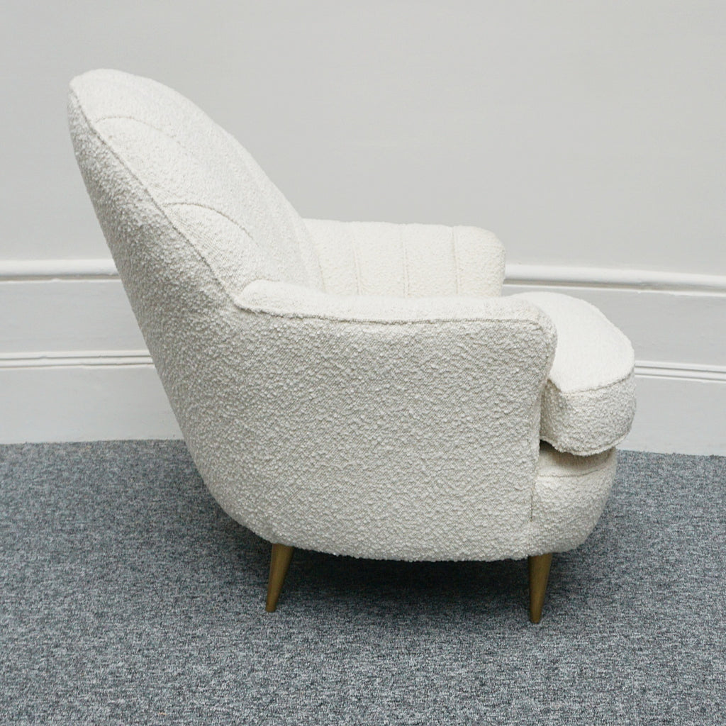 A pair of Mid Century lounge chairs upholstered in white Bouclé with metal and brass capped feet. Designed by Gigi Raddice for Minotti. 