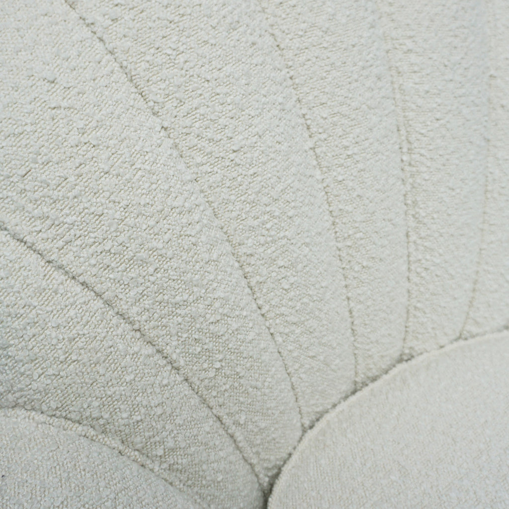 A pair of Mid Century lounge chairs upholstered in white Bouclé with metal and brass capped feet. Designed by Gigi Raddice for Minotti. 