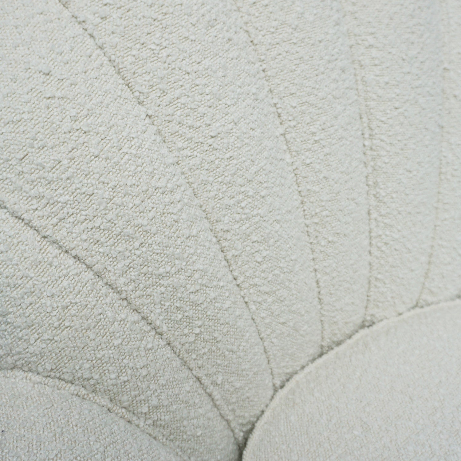 A pair of Mid Century lounge chairs upholstered in white Bouclé with metal and brass capped feet. Designed by Gigi Raddice for Minotti. 