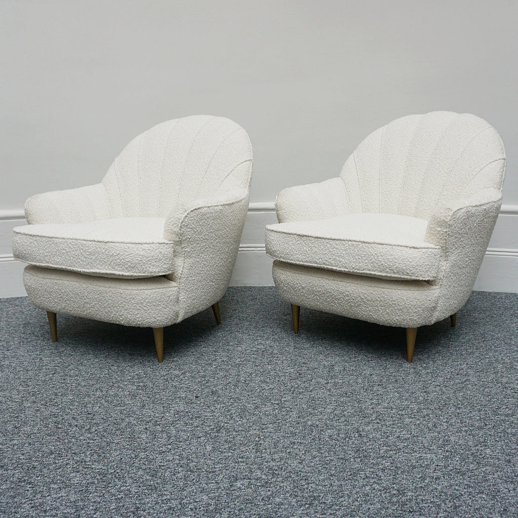 A pair of Mid Century lounge chairs upholstered in white Bouclé with metal and brass capped feet. Designed by Gigi Raddice for Minotti. 