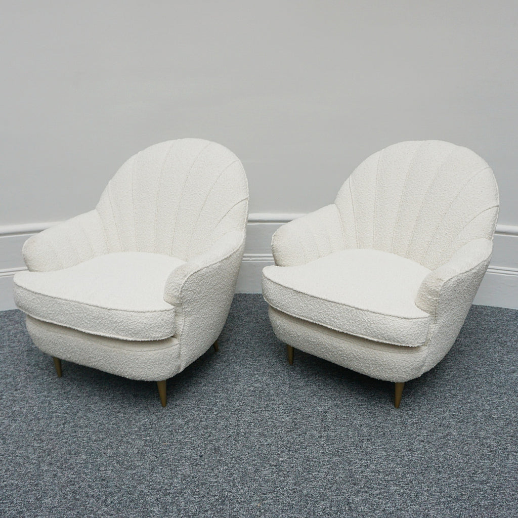 A pair of Mid Century lounge chairs upholstered in white Bouclé with metal and brass capped feet. Designed by Gigi Raddice for Minotti. 