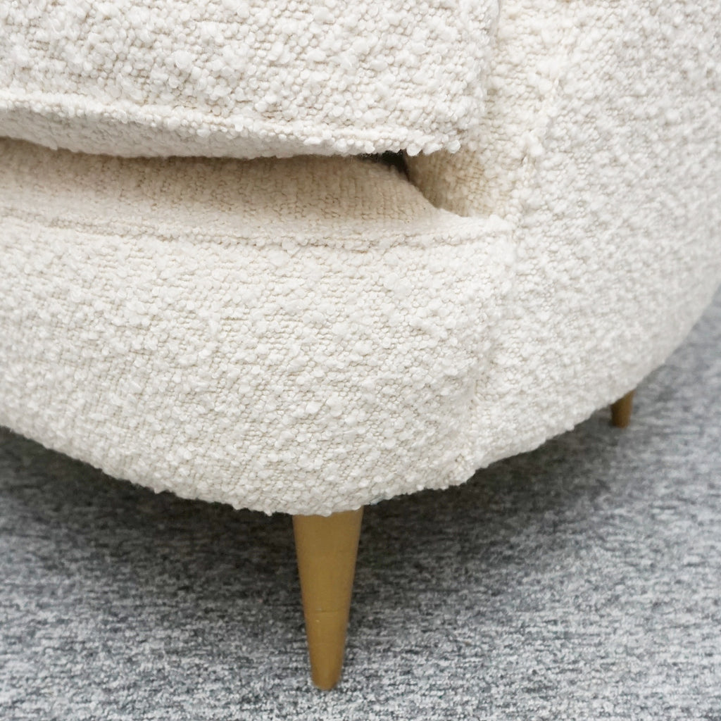 A pair of Mid Century lounge chairs upholstered in white Bouclé with metal and brass capped feet. Designed by Gigi Raddice for Minotti. 