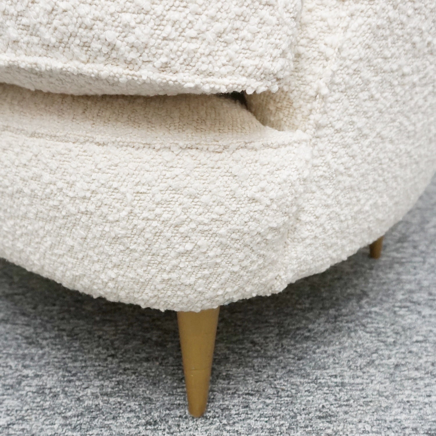 A pair of Mid Century lounge chairs upholstered in white Bouclé with metal and brass capped feet. Designed by Gigi Raddice for Minotti. 