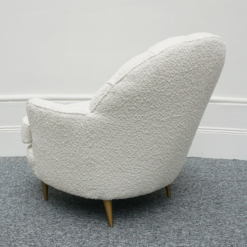 A pair of Mid Century lounge chairs upholstered in white Bouclé with metal and brass capped feet. Designed by Gigi Raddice for Minotti. 