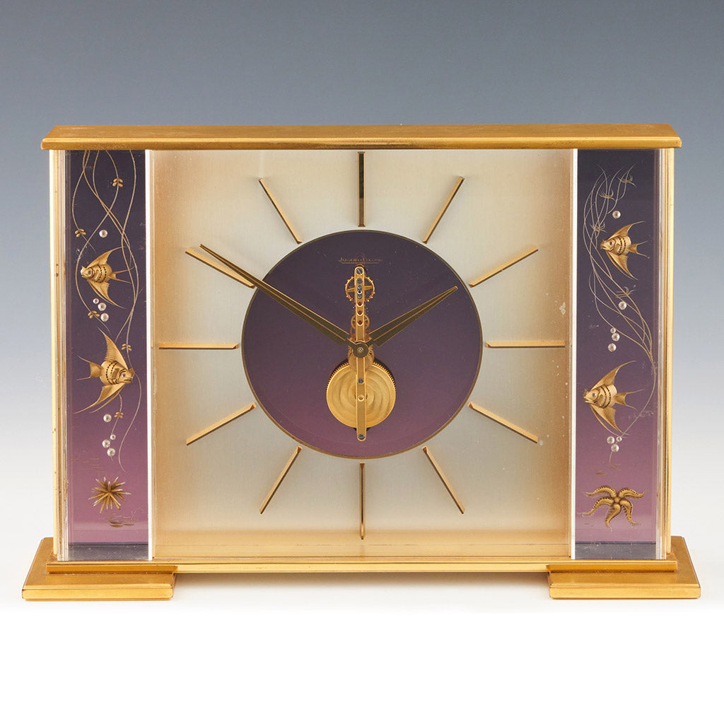 Mid century mantel clock by Jaeger-LeCoultre with brass fish decoration and a central square dial with a skeletonised 8 day movement