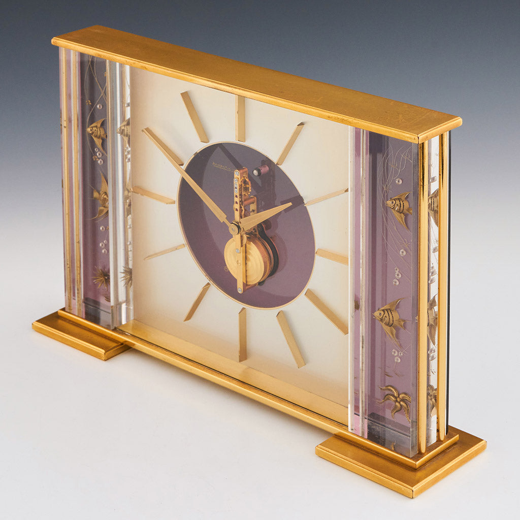 Mid century mantel clock by Jaeger-LeCoultre with brass fish decoration and a central square dial with a skeletonised 8 day movement