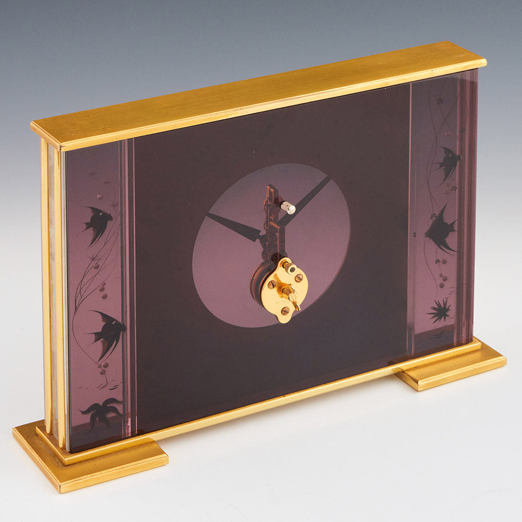 Mid century mantel clock by Jaeger-LeCoultre with brass fish decoration and a central square dial with a skeletonised 8 day movement