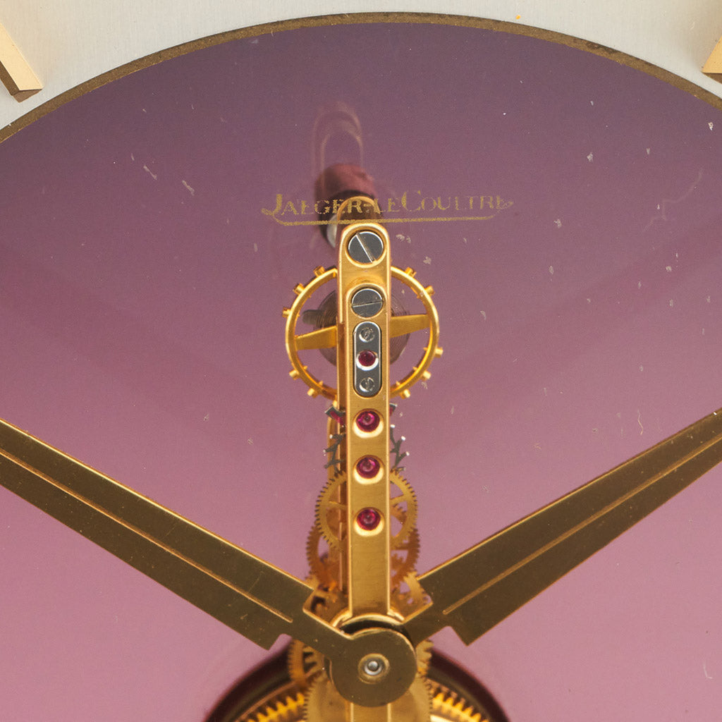 Mid century mantel clock by Jaeger-LeCoultre with brass fish decoration and a central square dial with a skeletonised 8 day movement