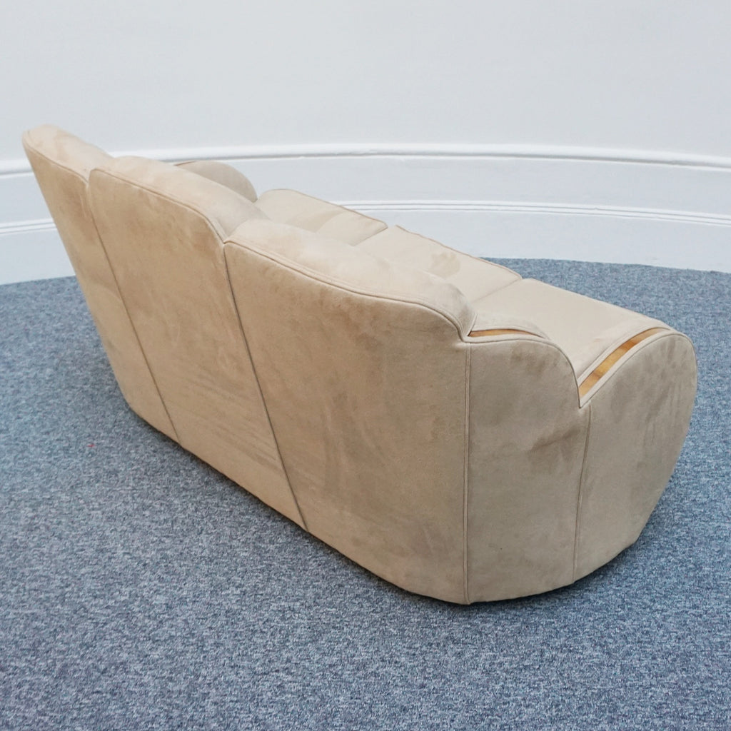 An Art Deco cloud back sofa by Harry & Lou Epstein with figured walnut banding to the arms and upholstered in cream faux suede