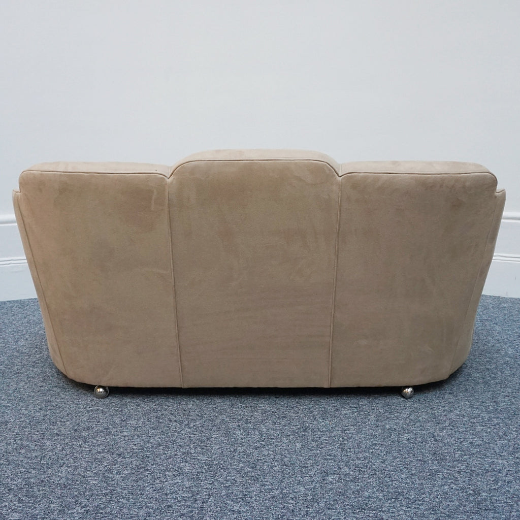 An Art Deco cloud back sofa by Harry & Lou Epstein with figured walnut banding to the arms and upholstered in cream faux suede