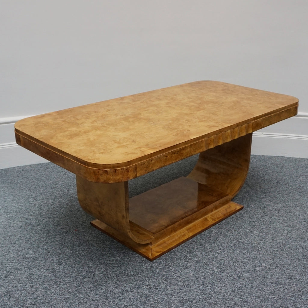 An Art Deco dining table by Harry & Lou Epstein. The table top is burr walnut veneered. 