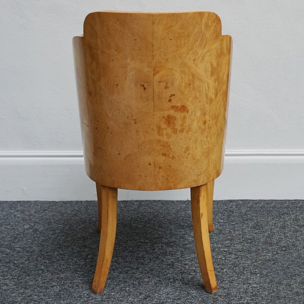 An art deco dining table with 6 chairs by Harry & Lou Epstein. The table top and cloud back armchairs are veneered in burr walnut. The chairs are upholstered in cream faux suede. 