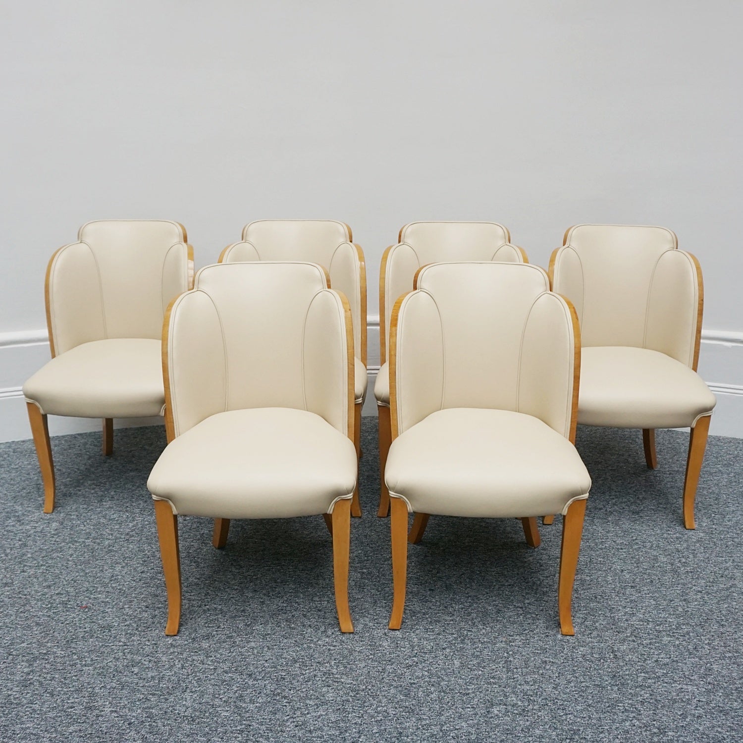 Art Deco cloud backed armchairs upholstered in cream leather by Harry & Lou Epstein. 