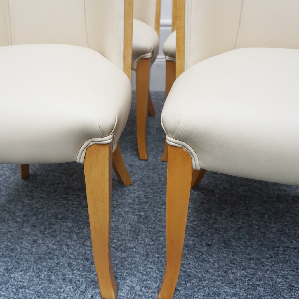 Art Deco cloud backed armchairs upholstered in cream leather by Harry & Lou Epstein. 