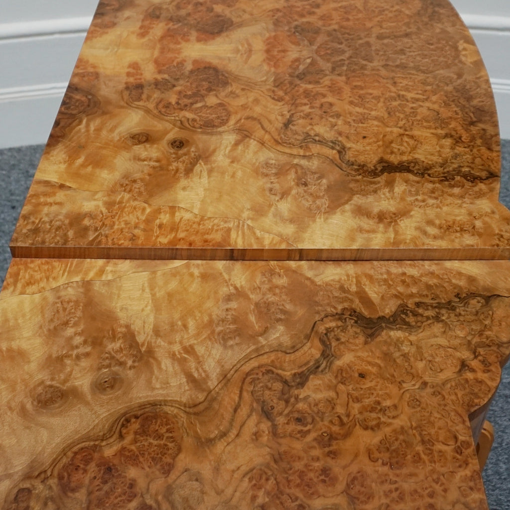 An Art Deco Sideboard by Harry & Lou Epstein with fluted sides set over a curved walnut base made of solid mahogany with burr walnut veneer
