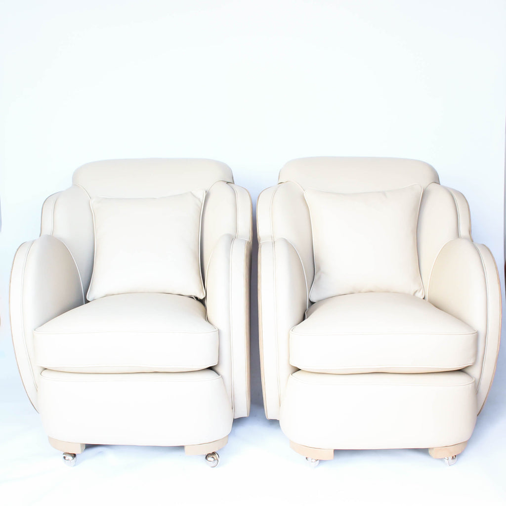 A pair of Art Deco, cloud back armchairs, re-leathered in cream leather at Jeroen Markies.
