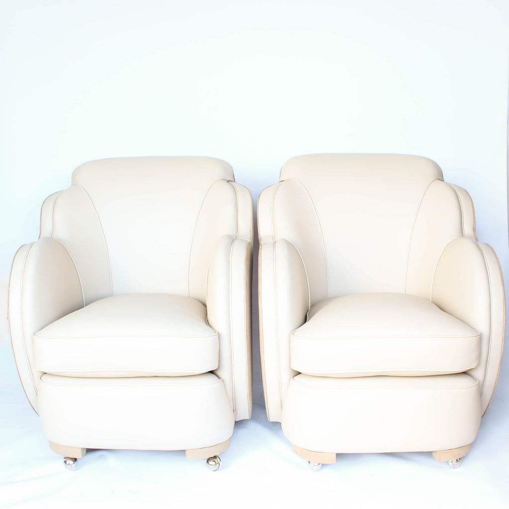 A pair of Art Deco, cloud back armchairs, re-leathered in cream leather at Jeroen Markies.