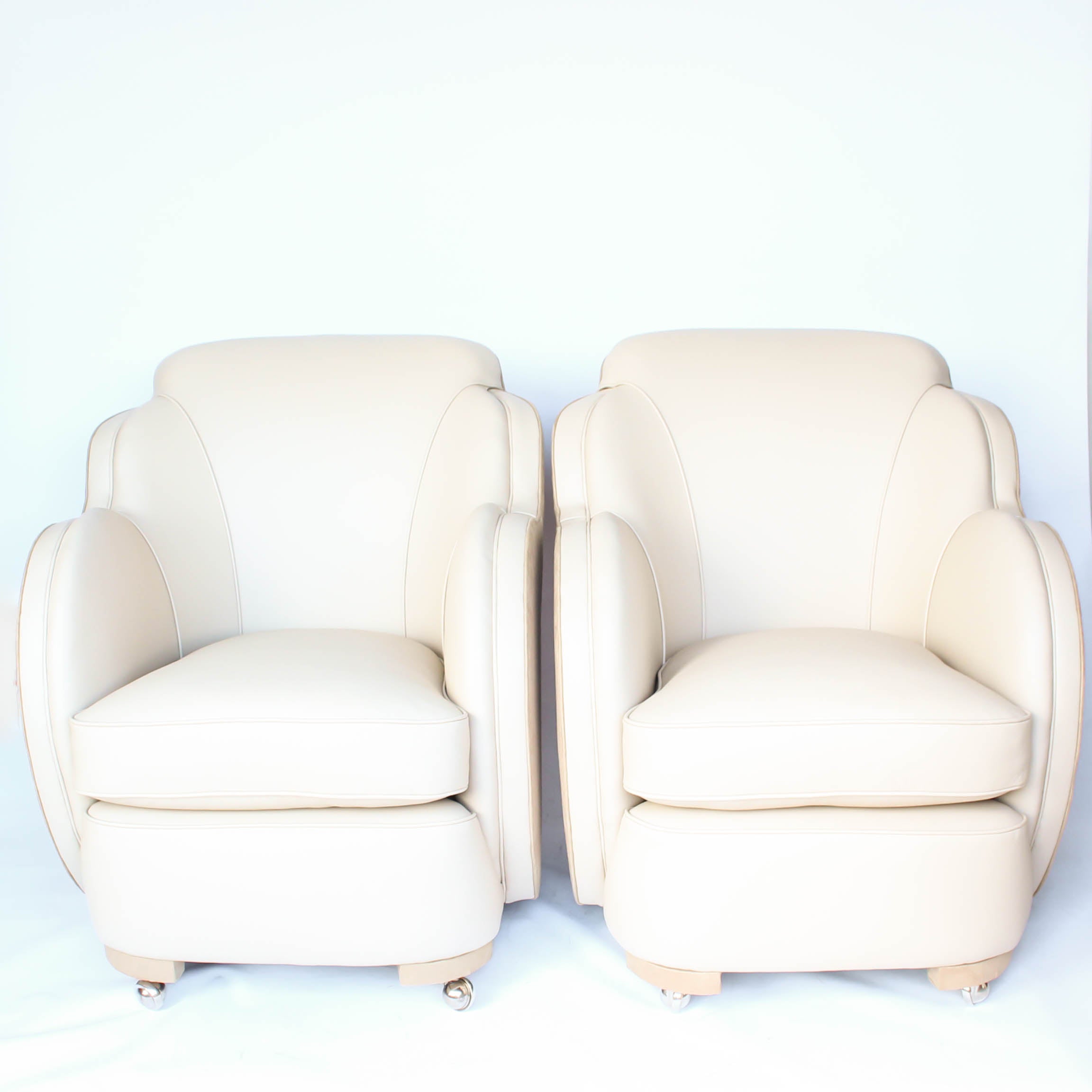 A pair of Art Deco, cloud back armchairs, re-leathered in cream leather at Jeroen Markies.