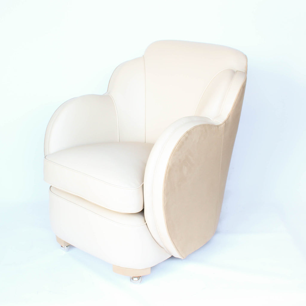 A pair of Art Deco, cloud back armchairs, re-leathered in cream leather at Jeroen Markies.