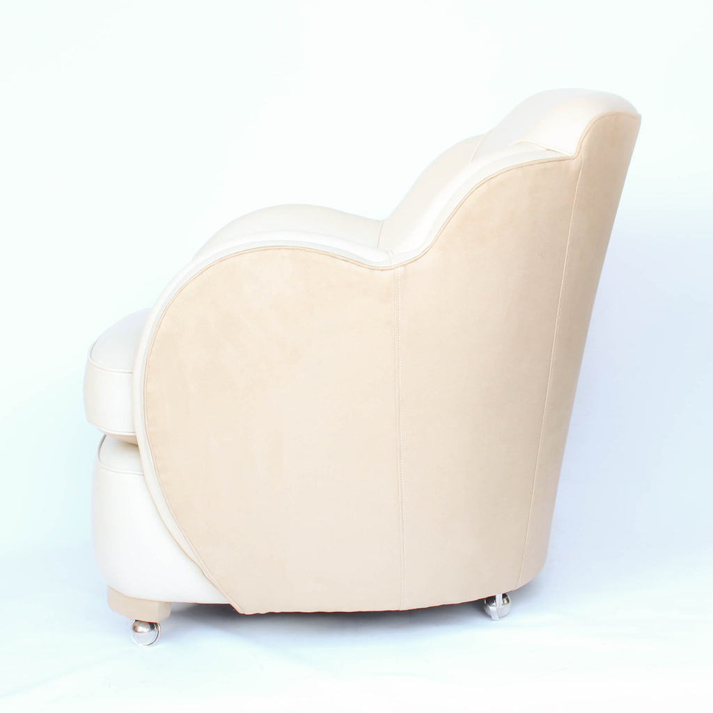 A pair of Art Deco, cloud back armchairs, re-leathered in cream leather at Jeroen Markies.
