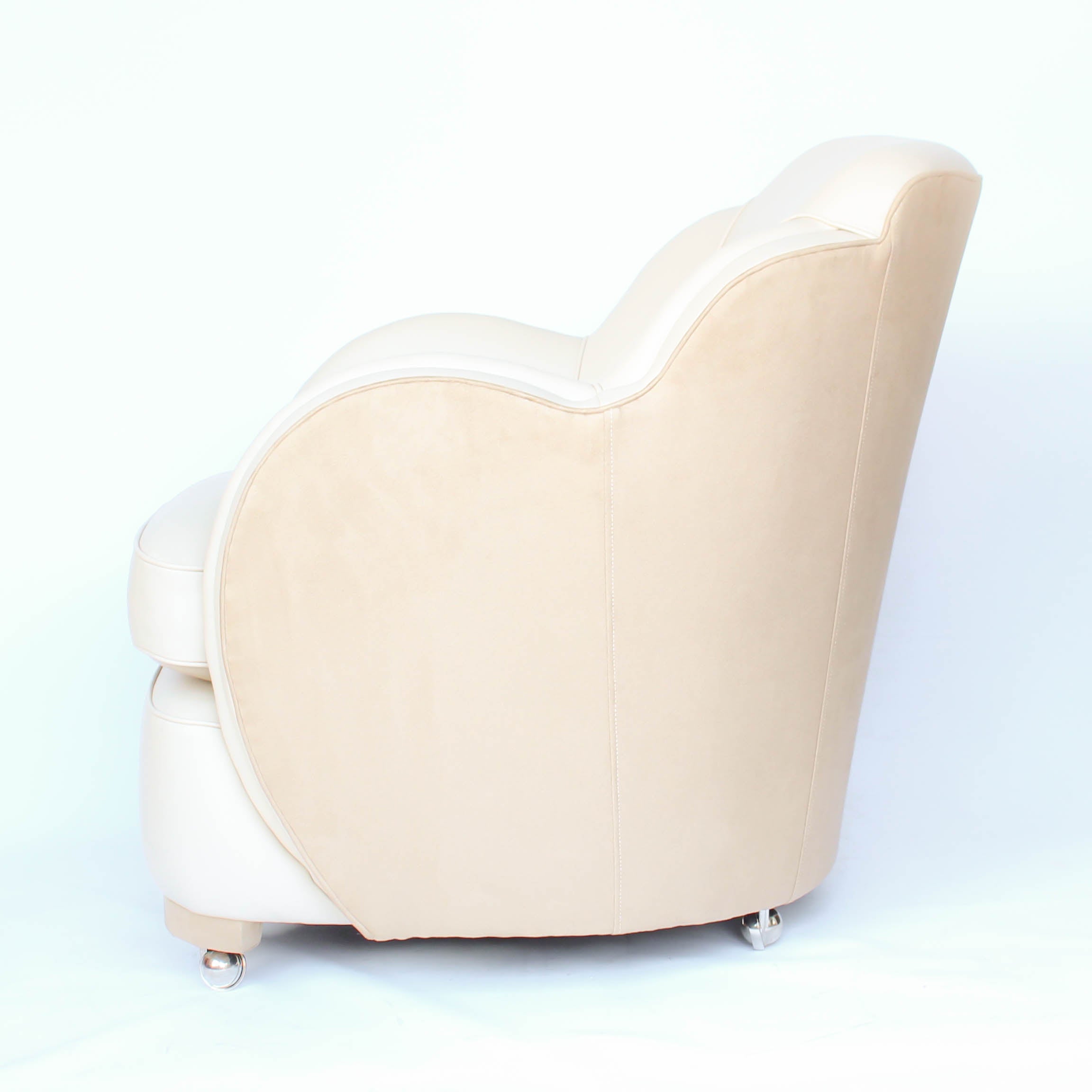 A pair of Art Deco, cloud back armchairs, re-leathered in cream leather at Jeroen Markies.