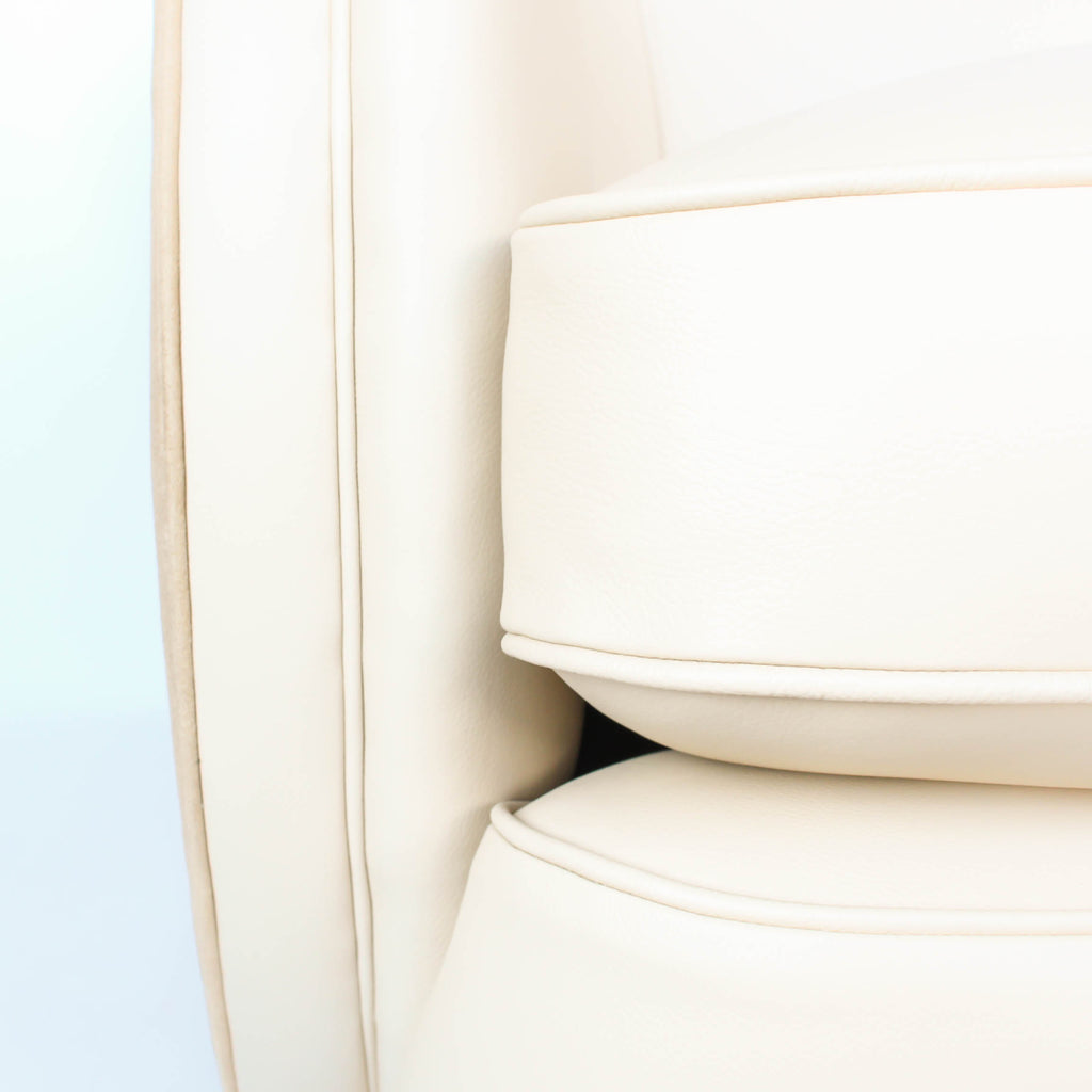 A pair of Art Deco, cloud back armchairs, re-leathered in cream leather at Jeroen Markies.