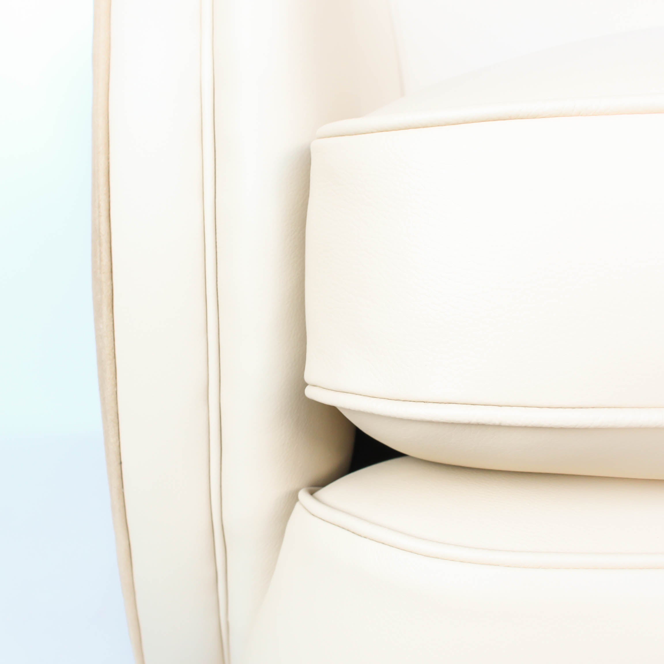 A pair of Art Deco, cloud back armchairs, re-leathered in cream leather at Jeroen Markies.