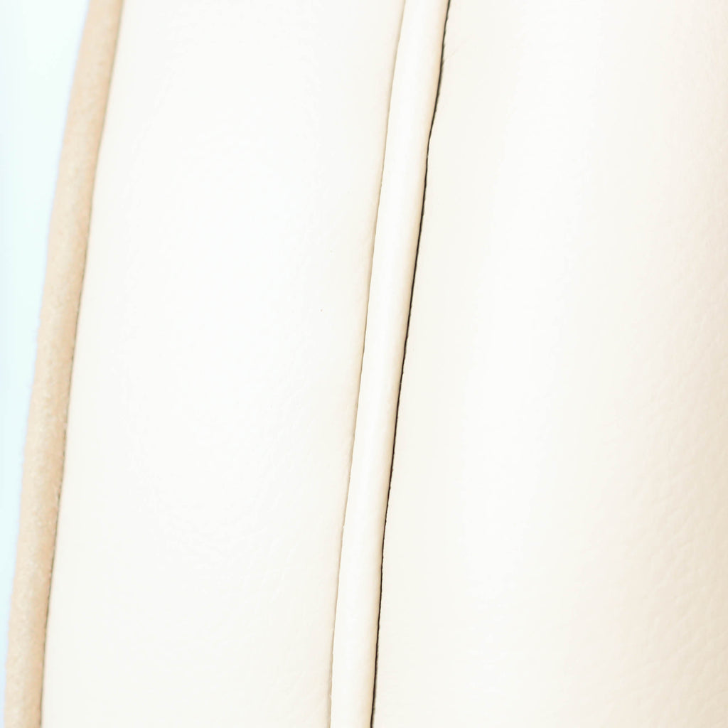 A pair of Art Deco, cloud back armchairs, re-leathered in cream leather at Jeroen Markies.