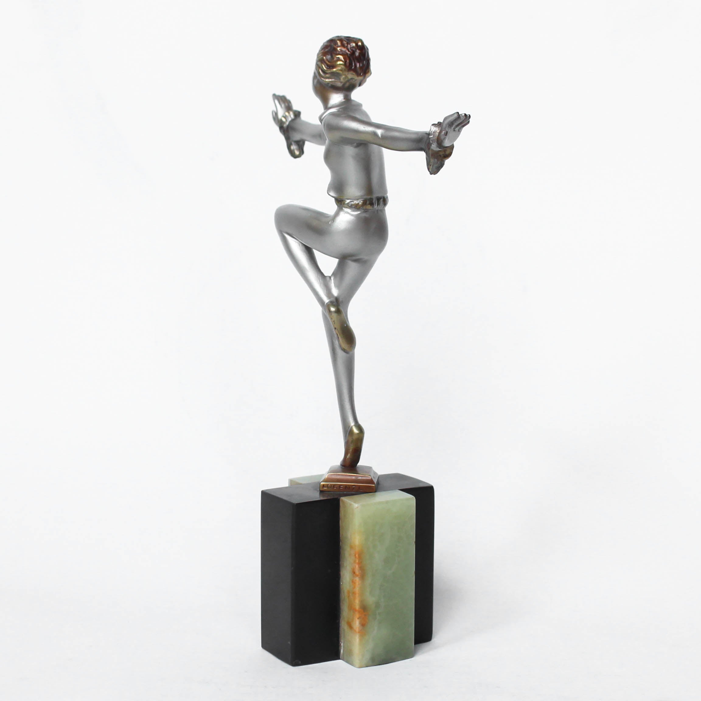 An Art Deco, cold painted bronze figure by Josef Lorenzl (1892-1950). A dancing woman in stylised pose set over a green onyx plinth at Jeroen Markies