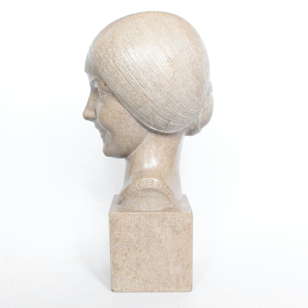 An Art Deco, stone carved sculpture of a smiling young lady, set over an integral plinth. Original dedication plaque to rear at Jeroen Markies.
