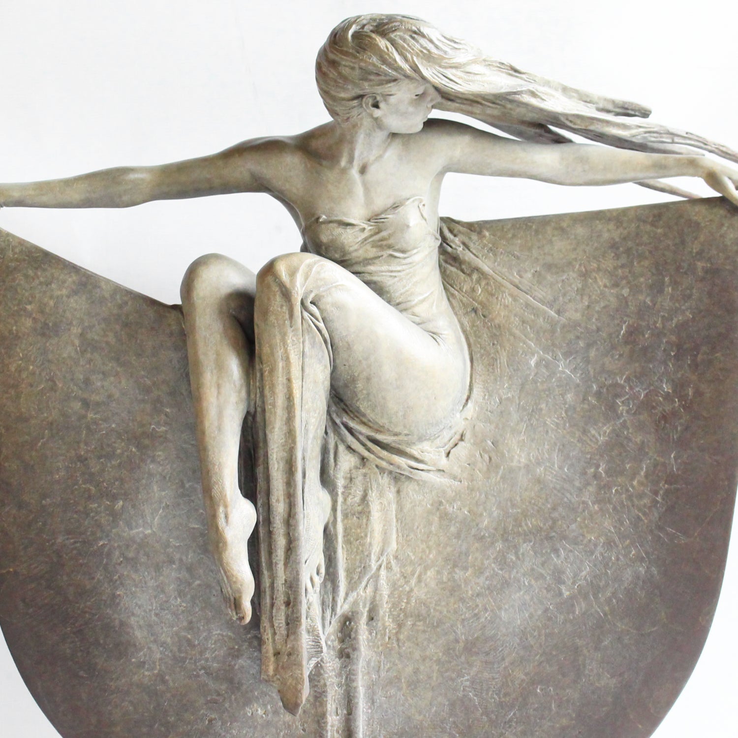 Grace, a limited edition, patinated bronze figure of a dancer in draping robe. Set over a granite plinth.  After completing a Masters degree at the Royal Academy in London 1980, Michael Talbot was led to working under Colin Melbourne ARCA and Dame Elizabeth Frink RA. He was elected to the Royal British Society of Sculptors in 1997.  Signed and numbered edition of 12